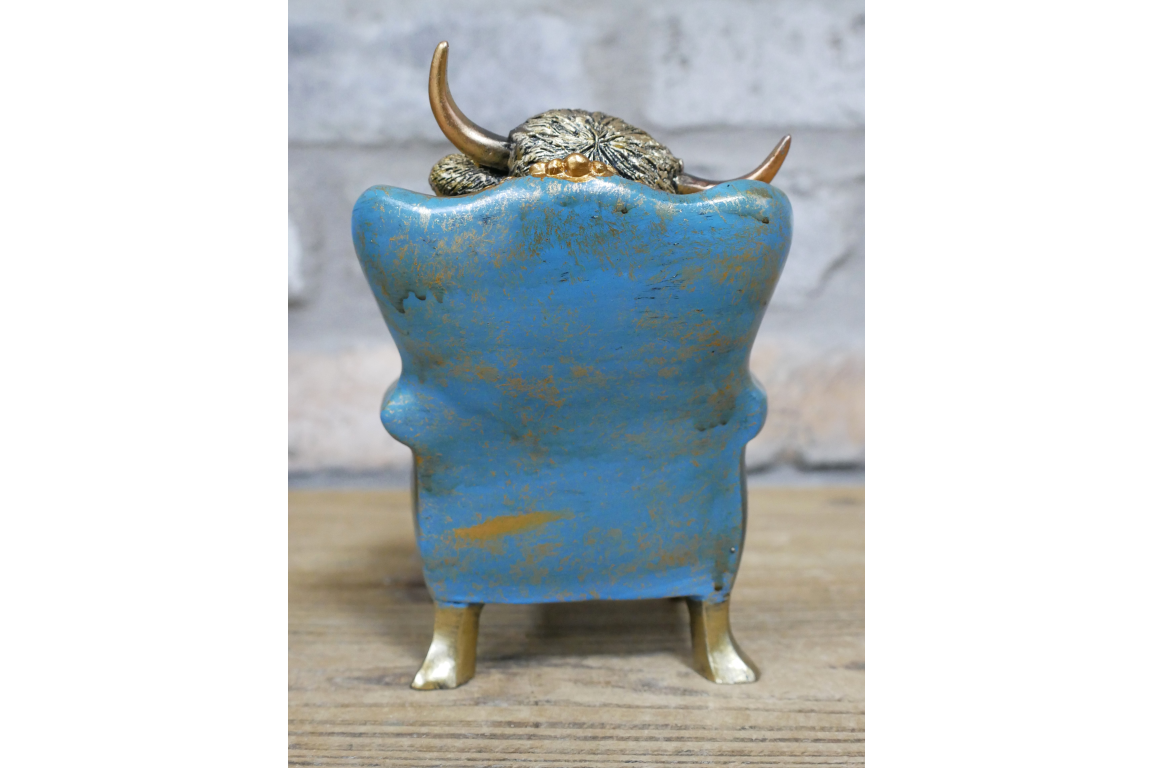 Highland Cow sat on chair