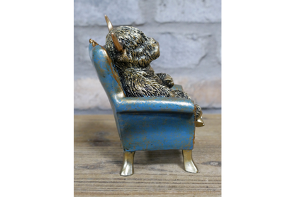 Highland Cow sat on chair