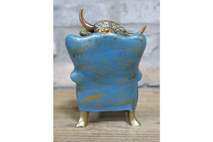 Highland Cow sat on chair