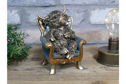 Highland Cow sat on chair