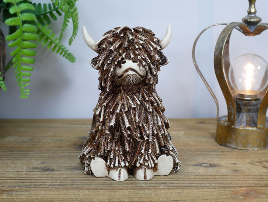 Sitting Shaggy Highland Cow